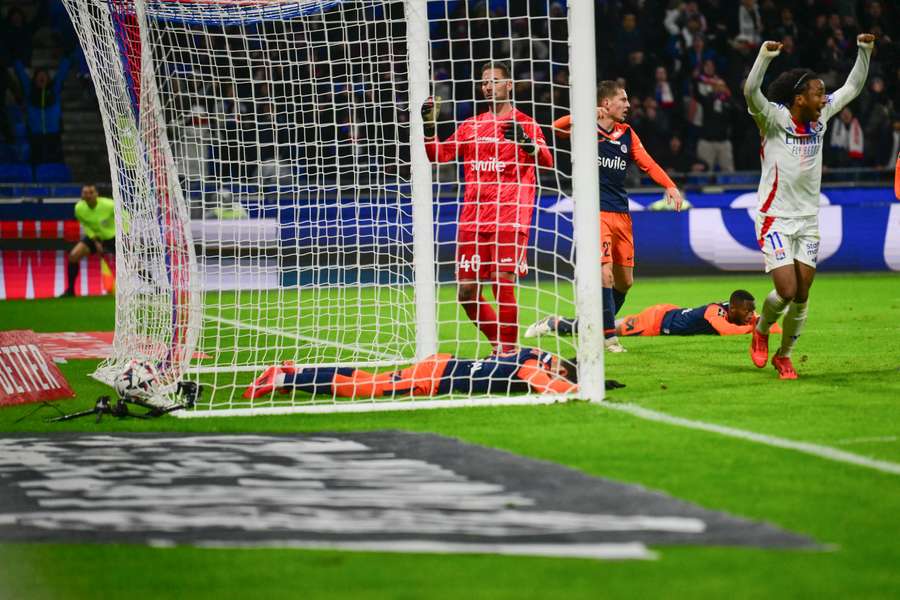 Montpellier players fall to the floor following Lyon's late winner.