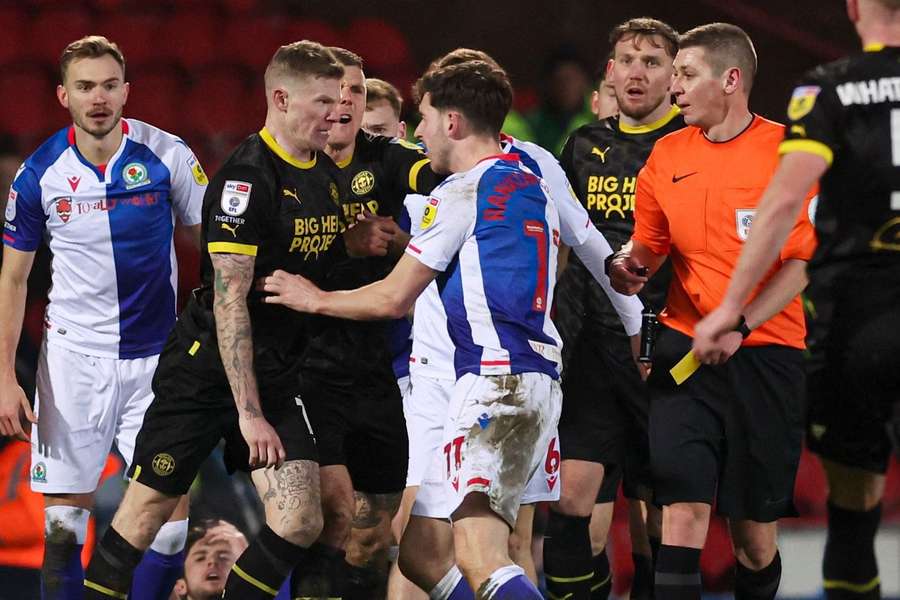 James McClean of Wigan Athletic and Joseph Rankin-Costello of Blackburn Rovers  clash during the game