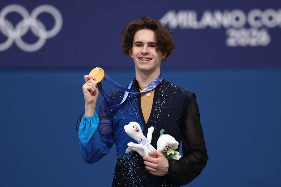 Mikhail Shaidorov poses with the gold medal at 2026 Winter Olympics