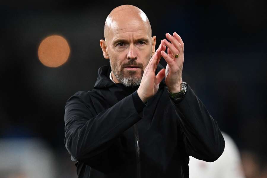 Erik ten Hag applauds fans on the pitch after the English Premier League football match between Burnley and Manchester United