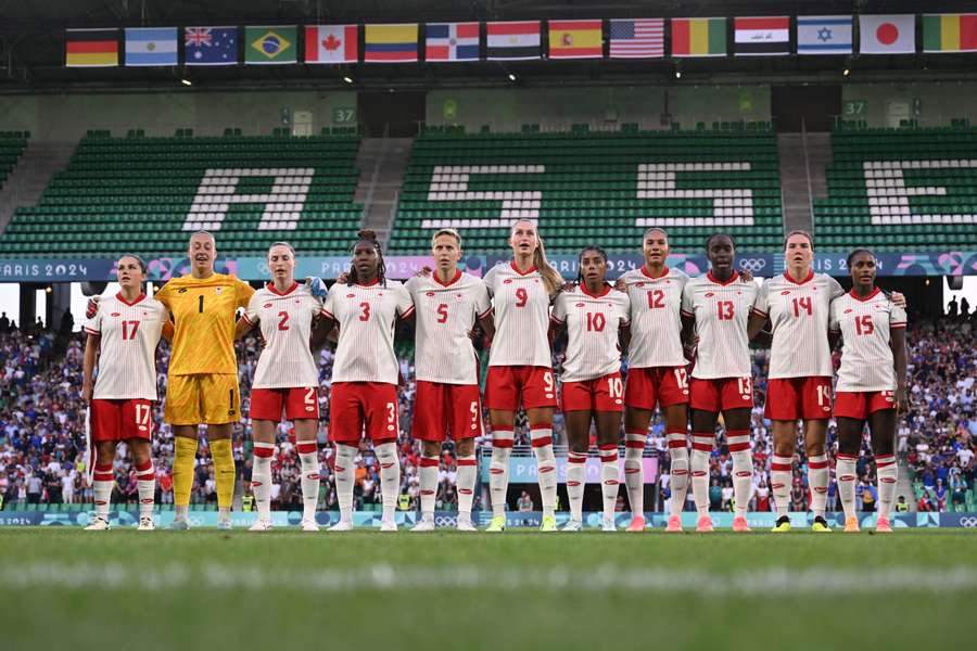 Team Canada sing their national anthem on pitch ahead of the Women's group A match between France and Canada