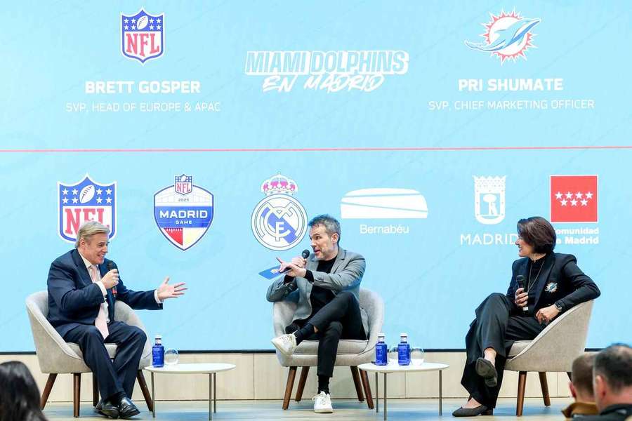 NFL's Brett Gosper, left, and Miami Dolphins Vice President Pri Shumate, right, speak during the presentation