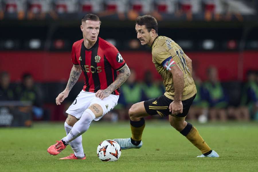 Melvin Bard of OGC Nice competes for the ball with Mikel Oyarzabal