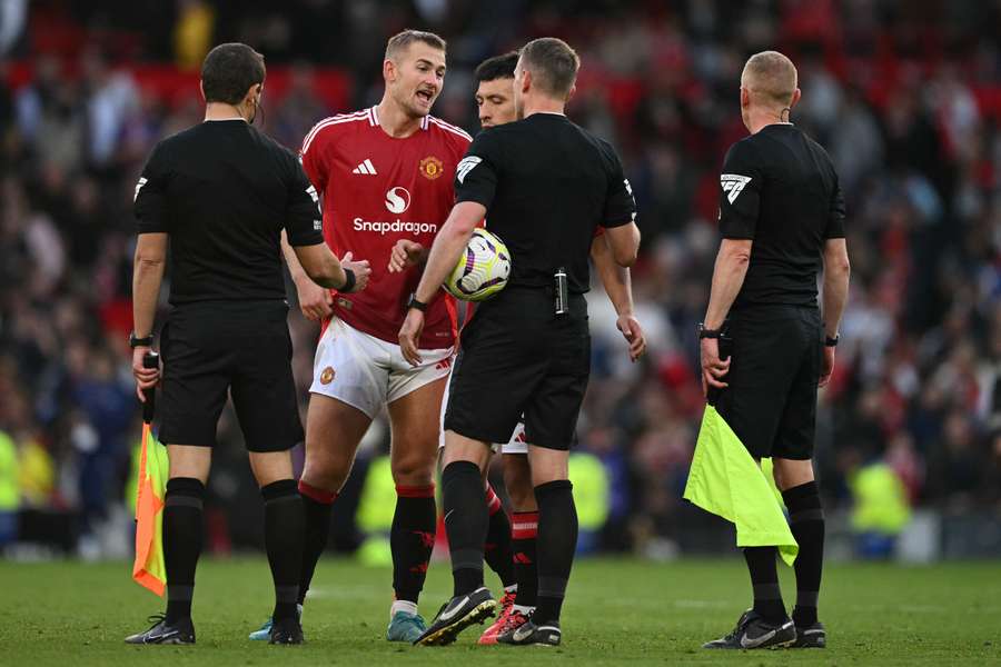 Manchester United defender Matthijs de Ligt speaks to referee Samuel Barrott