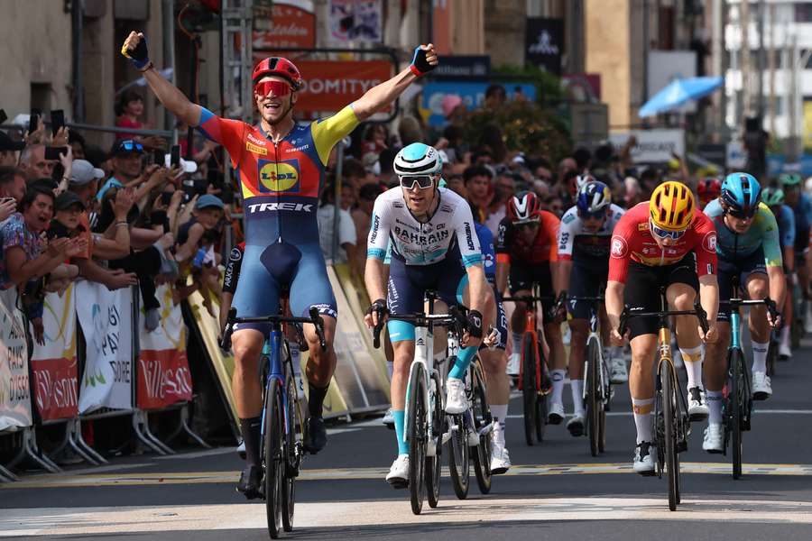 Jonathan Milan celebrates ahead of Fred Wright and Matheiu van der Poel
