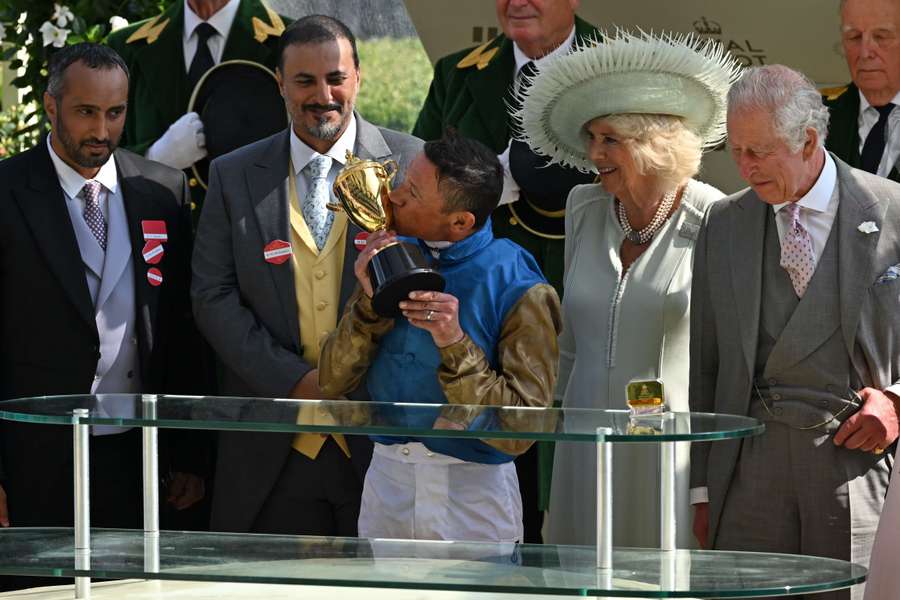 Jockey Frankie Dettori kisses the Gold Cup trophy at the presentation after his victory on Courage Mon Ami in the Ascot Gold Cup