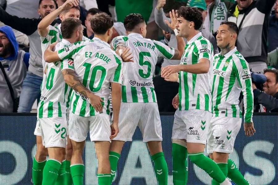 Marc Roca of Real Betis celebrates with teammate Marc Bartra after scoring his team's second goal against Real Sociedad