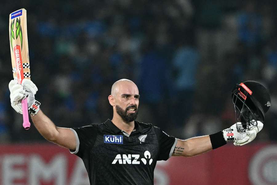 New Zealand's Daryl Mitchell celebrates after scoring his century against India in the second ODI