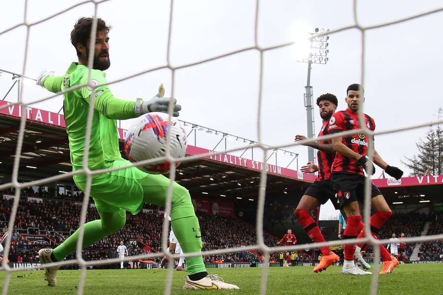 Bournemouth's Danish midfielder Philip Billing (2R) score the opening goal past Liverpool's Brazilian goalkeeper Alisson Becker (L)