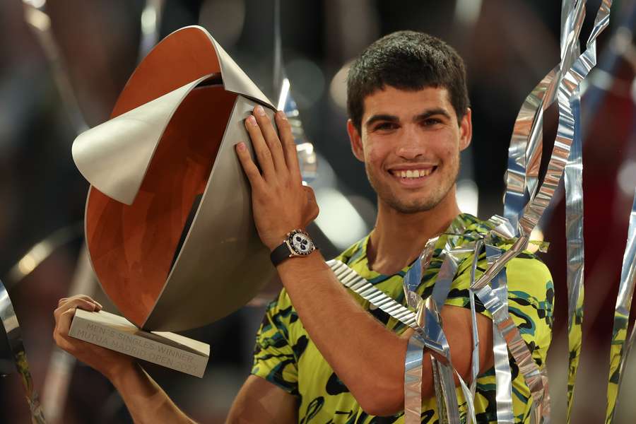 Spain's Carlos Alcaraz poses for pictures with the trophy after winning the 2023 ATP Tour Madrid Open 