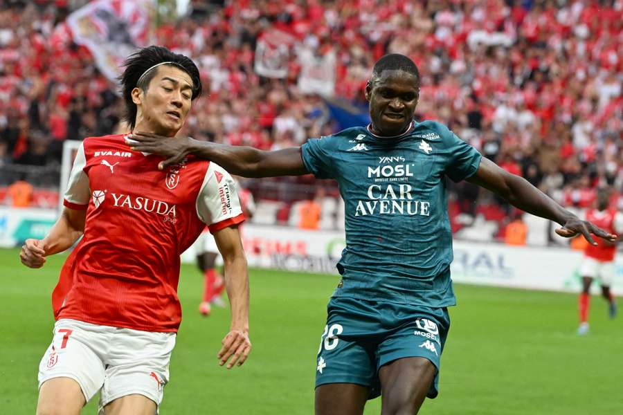 Metz's Senegalese defender Sadibou Sane (right) battles for the ball