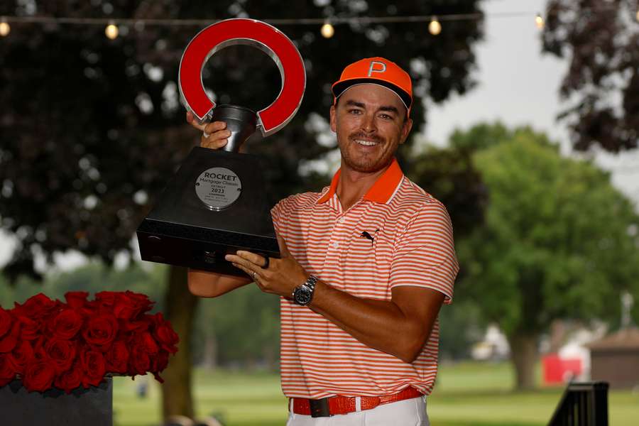 Rickie Fowler of the United States poses with the trophy after defeating Adam Hadwin of Canada