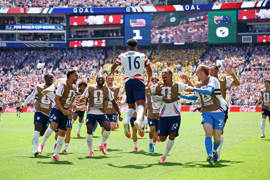 Alex Freeman celebrates with with teammates after doubling USA's lead over Australia
