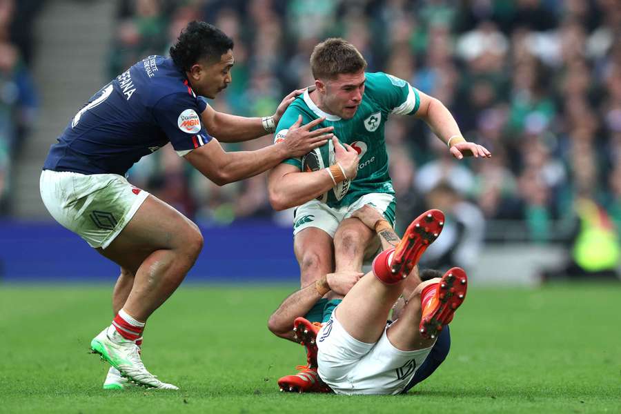Ireland's Jack Crowley is tackled by France's Romain Ntamack and Youram Moefana during their Six Nations clash last weekend
