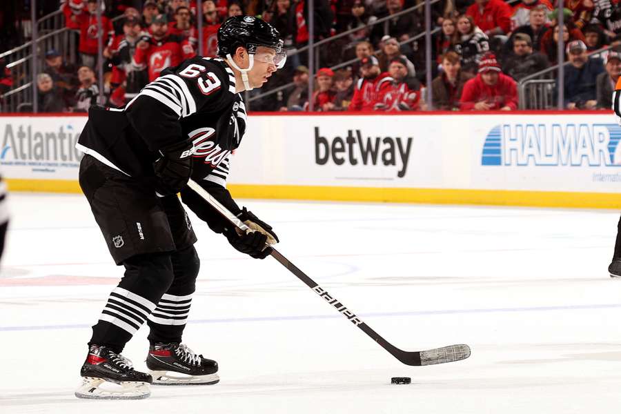 Jesper Bratt of the New Jersey Devils heads for the net and scores the game-winning goal against the Vancouver Canucks