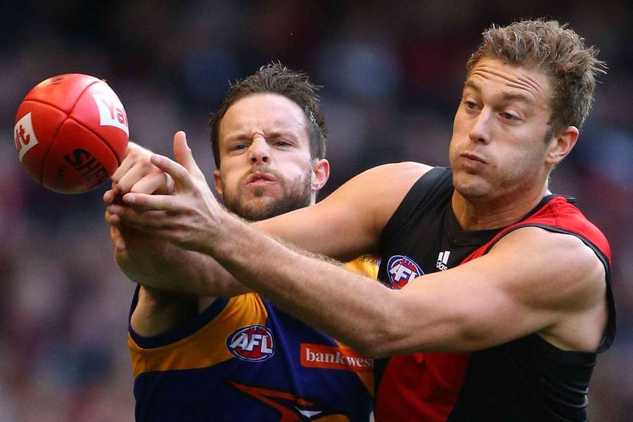 Mitch Brown contests a mark with Essendon's Tom Bellchambers.
