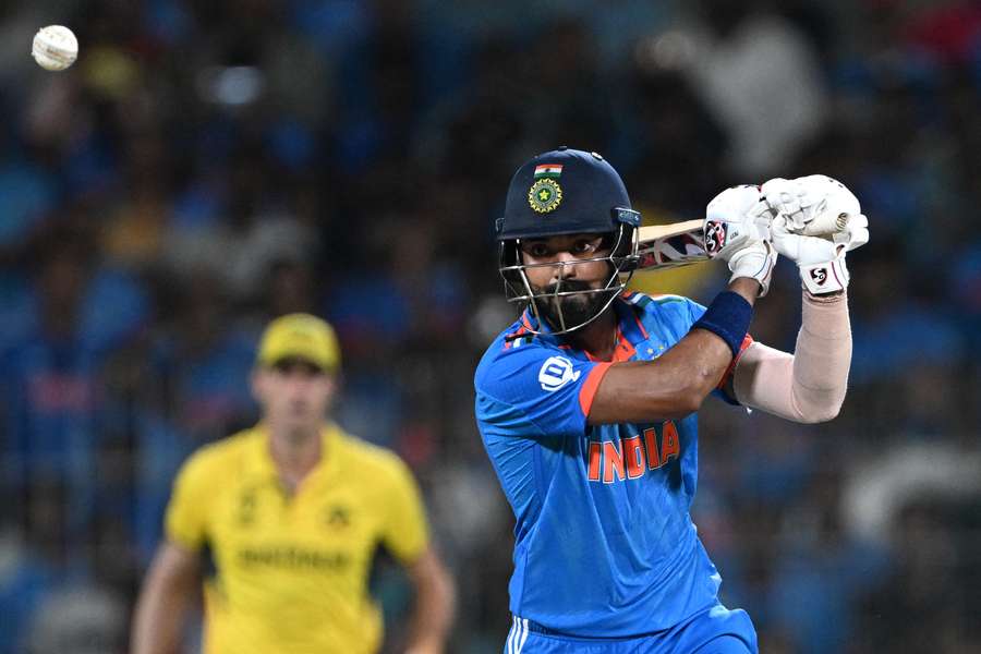 India's KL Rahul (R) watches the ball after playing a shot