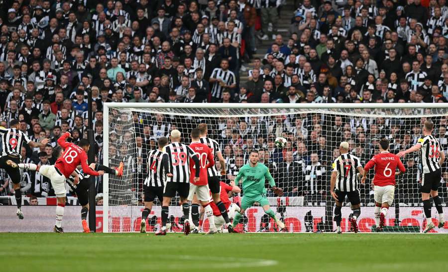 Manchester United's Brazilian midfielder Casemiro scores the opening goal past Newcastle United's German goalkeeper Loris Karius