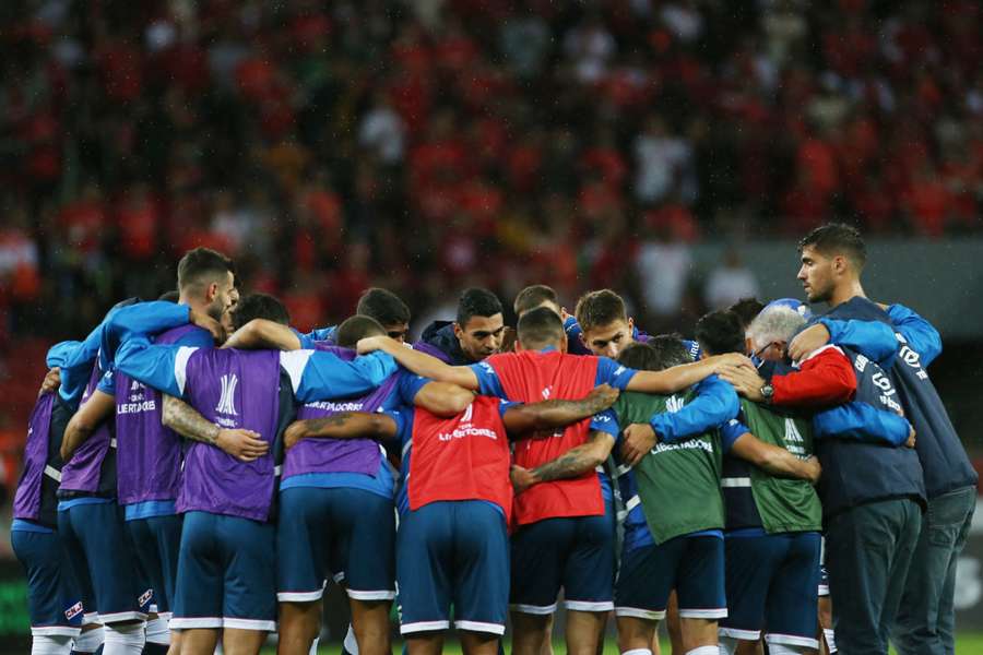 Nacional players huddle during the warm up before the matc