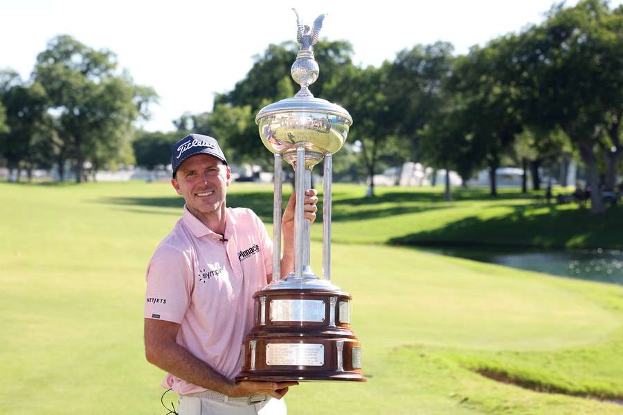 Russell Henley poses with the winner's trophy at the Charles Schwab Challenge Russell Henley poses with the winner's trophy at the Charles Schwab Challenge