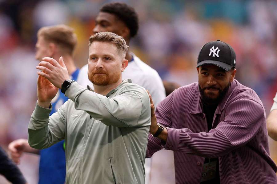 Reece James pushes interim manager Calum McFarlane to celebrate with fans after the match