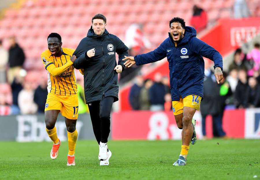 Brighton's Yankuba Minteh and Georginio Rutter celebrate with manager, Fabian Hurzeler, after a win over Southampton