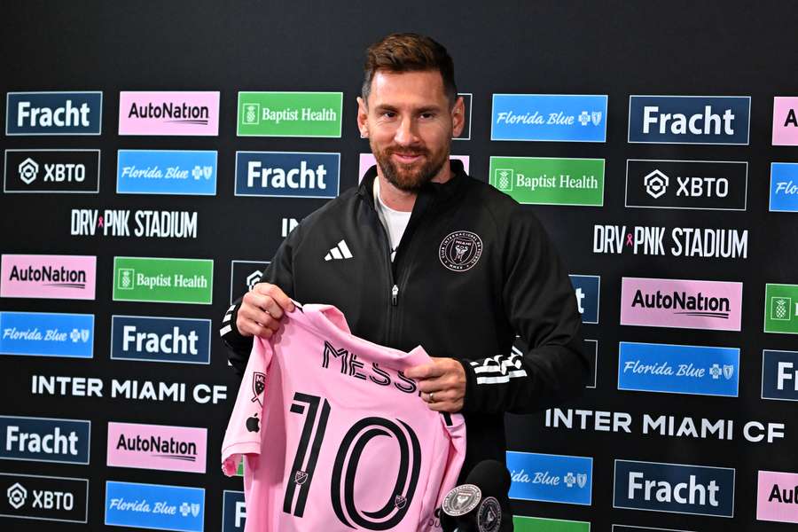 Inter Miami's Argentine forward Lionel Messi holds his jersey during a press conference