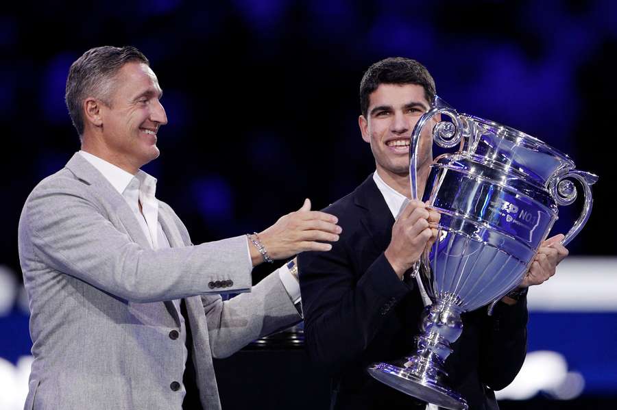 Andrea Gaudenzi hands Carlos Alcaraz the ATP world number one trophy in 2022