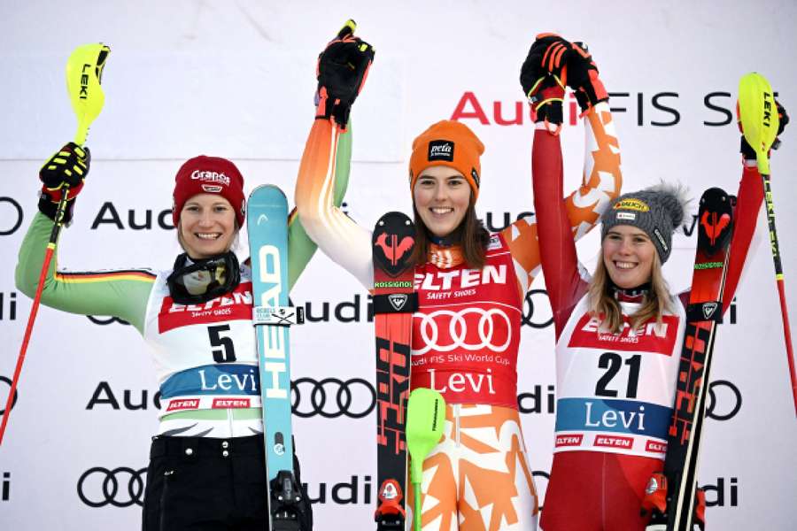 Petra Vlhova celebrates on the podium after winning the women's slalom alongside second-place Lena Duerr and third-place Katharina Liensberger