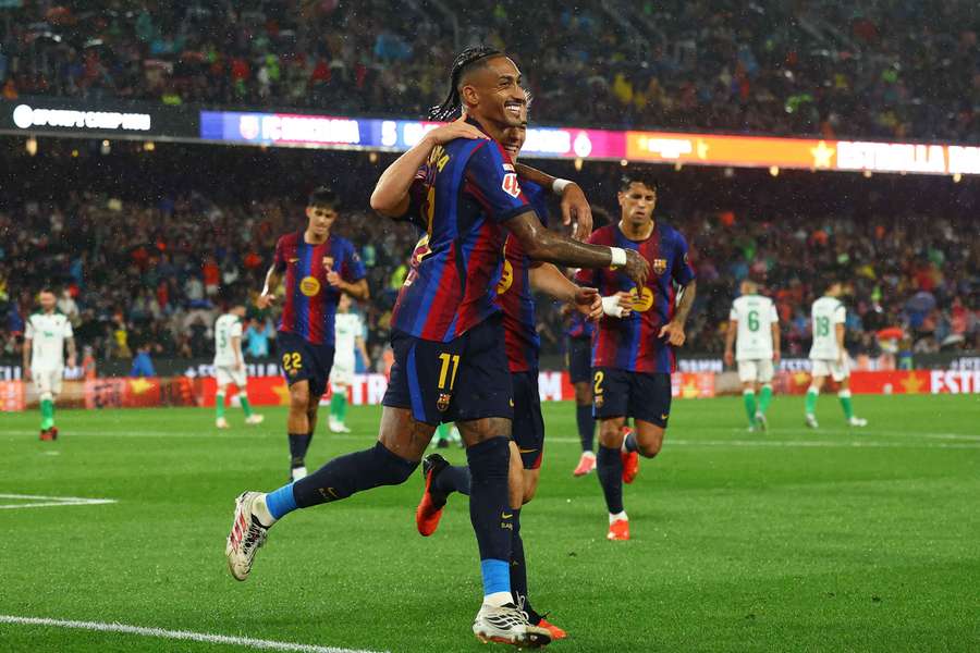 Raphinha celebrates with Gavi after scoring Barcelona's fifth goal to complete his hat-trick