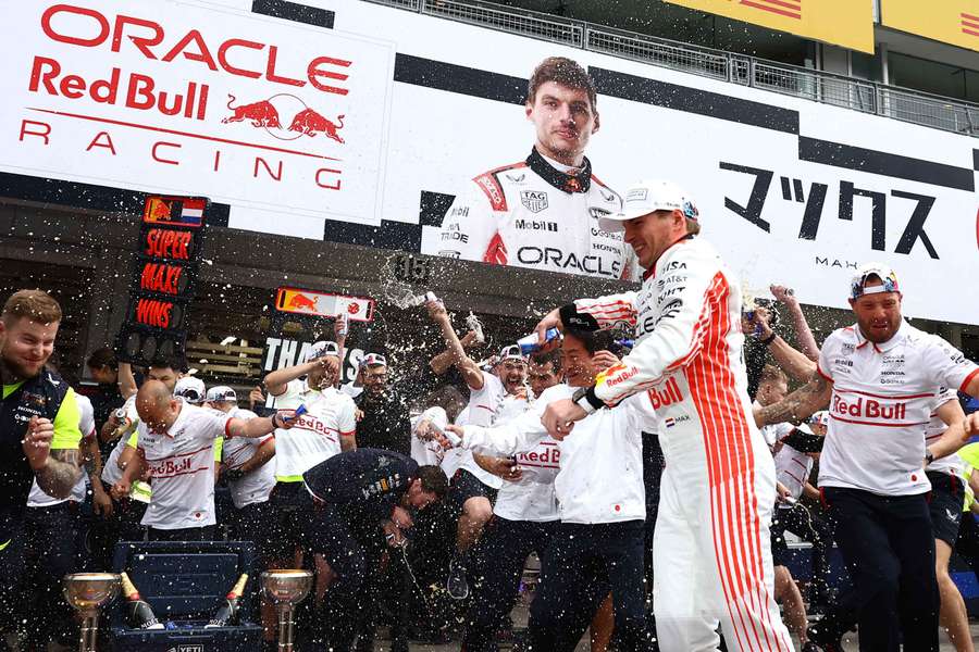 Verstappen celebrates with his team members after winning the Japanese Grand Prix