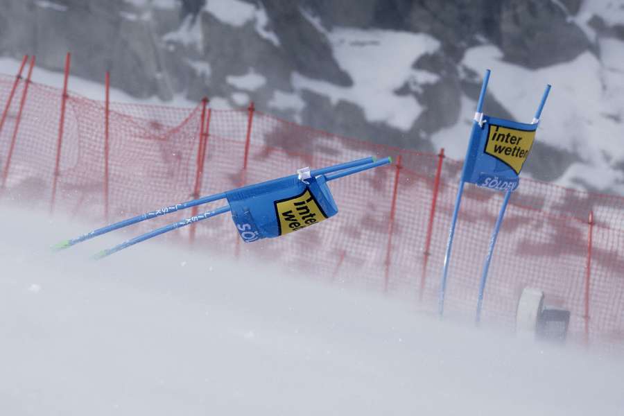 A ski gate is pictured as it gets hit by strong winds during the first run