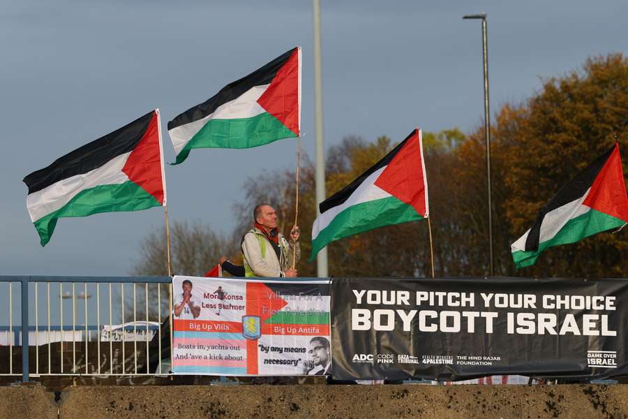 Pro-Palestine supporters display banners and flags ahead of Aston Villa's UEFA Europa League match against Maccabi Tel Aviv in Birmingham Pro-Palestine supporters display banners and flags ahead of Aston Villa's UEFA Europa League match against Maccabi Tel Aviv in Birmingham