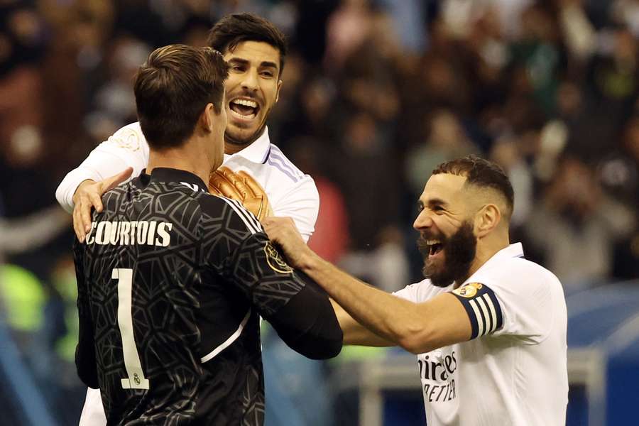 Karim Benzema (R), Thibaut Courtois en Marco Asensio vieren de overwinning