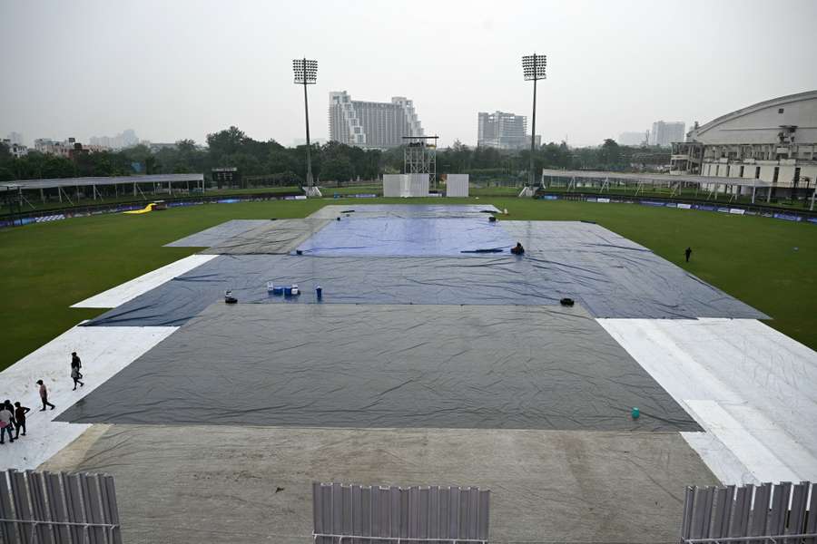 Groundsmen cover the field as it starts to rain on the eve of the one-off Test match between Afghanistan and New Zealand