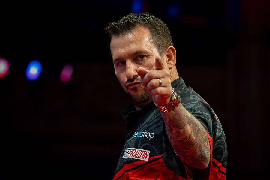 Clayton celebrates winning a leg against Van Barneveld