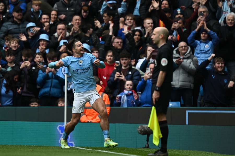 Jack Grealish celebrates scoring against Liverpool