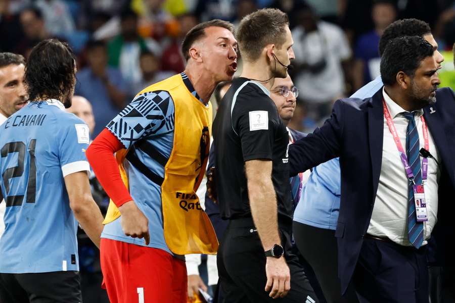 Daniel Siebert foi alvo da fúria dos jogadores do Uruguai, aqui com Muslera a vociferar