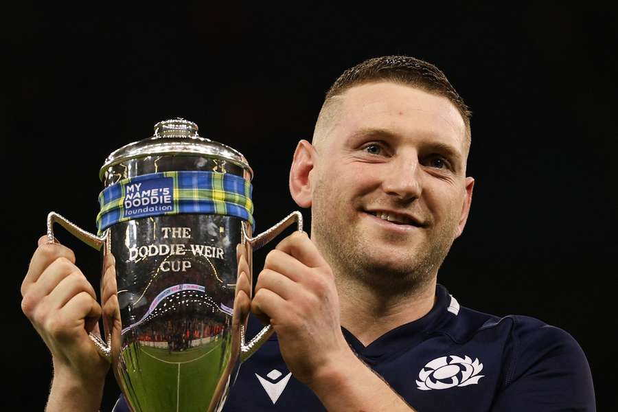 Scotland captain Finn Russell celebrates with the Doddie Weir Cup after his side's 27-26 Six Nations win over Wales in Cardiff
