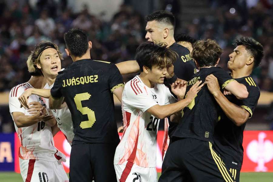 A scuffle breaks out between players from both teams during the first half of the match between Mexico and Japan A scuffle breaks out between players from both teams during the first half of the match between Mexico and Japan