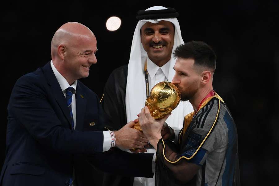 Infantino presenting the World Cup trophy to Argentina captain Lionel Messi