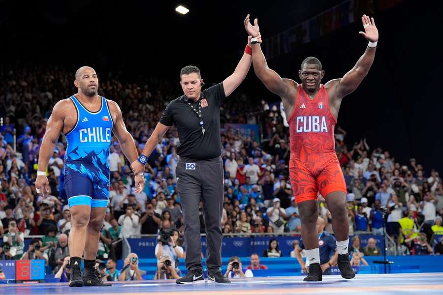 Cuba's Mijain Lopez Nunez celebrates after defeating Chile's Yasmani Acosta Fernandez