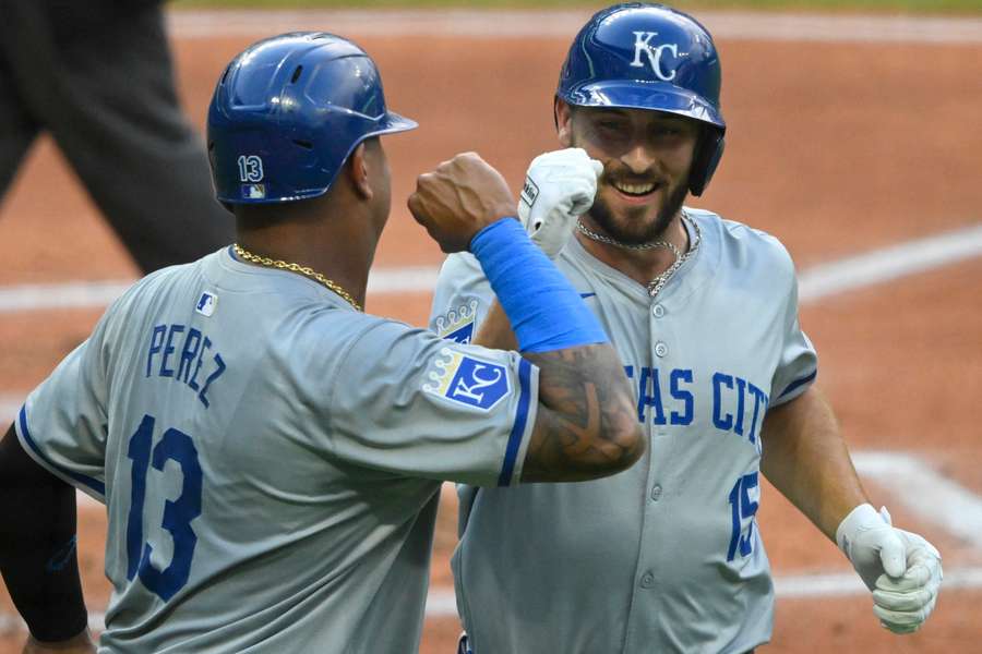 Kansas City Royals third baseman Paul DeJong celebrates his two-run home run with designated hitter Salvador Perez