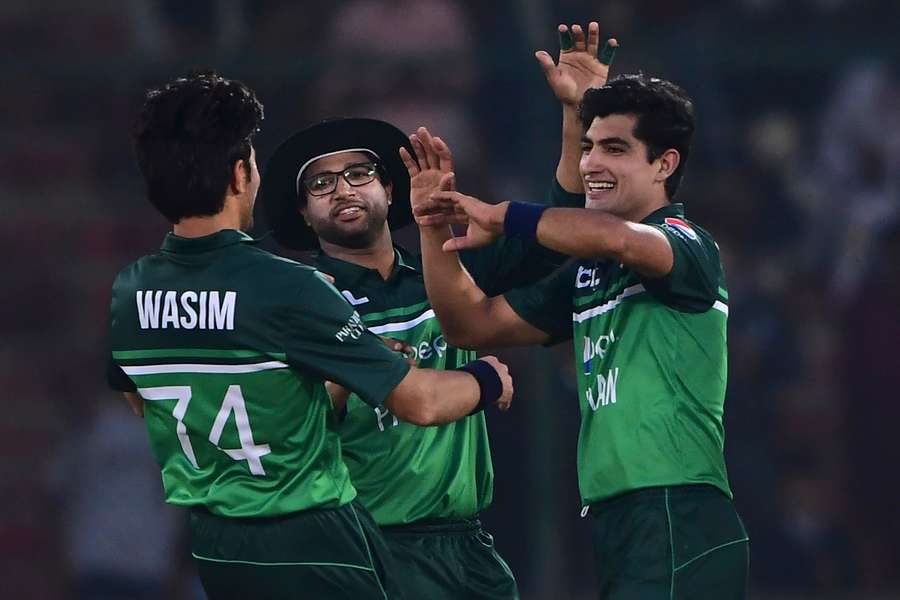 Pakistan's Naseem Shah celebrates with teammates after taking the wicket of New Zealand's Henry Shipley