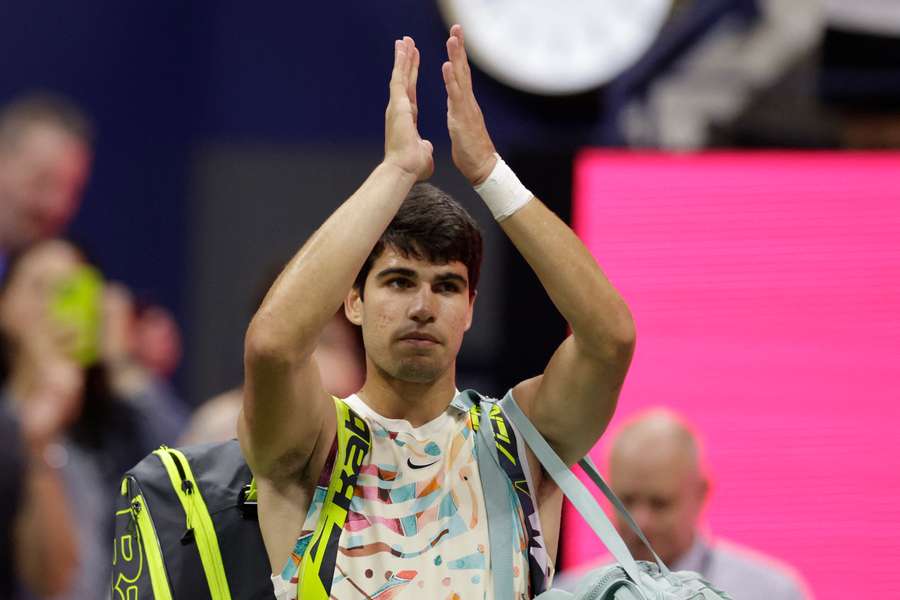 Spain's Carlos Alcaraz waves to fans as he leaves the court after his US Open semi-final loss