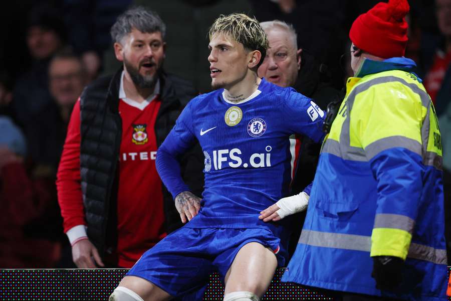 Garnacho celebrated by sitting on an advertising board