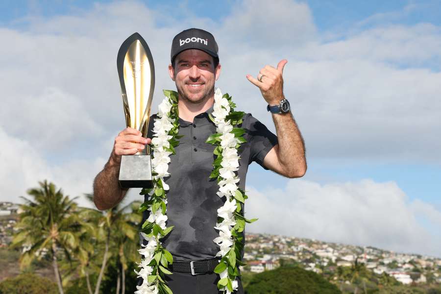 Nick Taylor poses with the trophy after defeating Nico Echavarria in a play-off to win the Sony Open in Hawaii