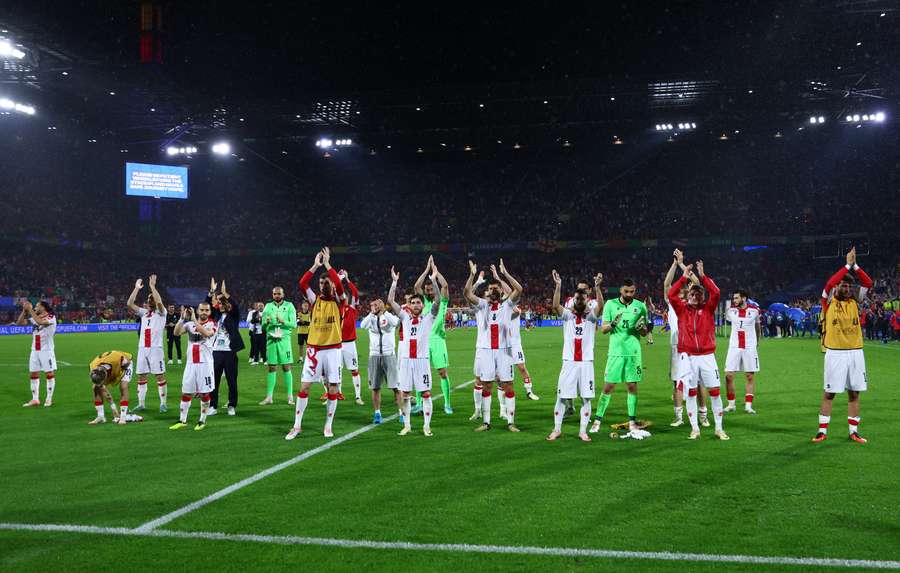 Georgia's players applaud their fans after the defeat