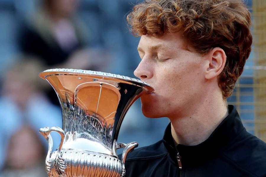 Jannik Sinner celebrates with the trophy after winning his men's final match against Casper Rudd