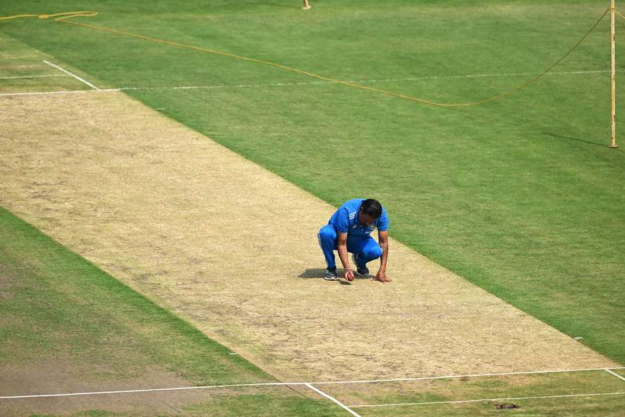An India team official inspects the pitch at Ranchi on the eve of the fourth Test